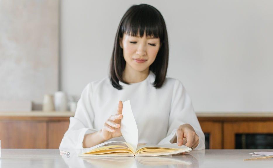Marie Kondo flipping through pages of a book