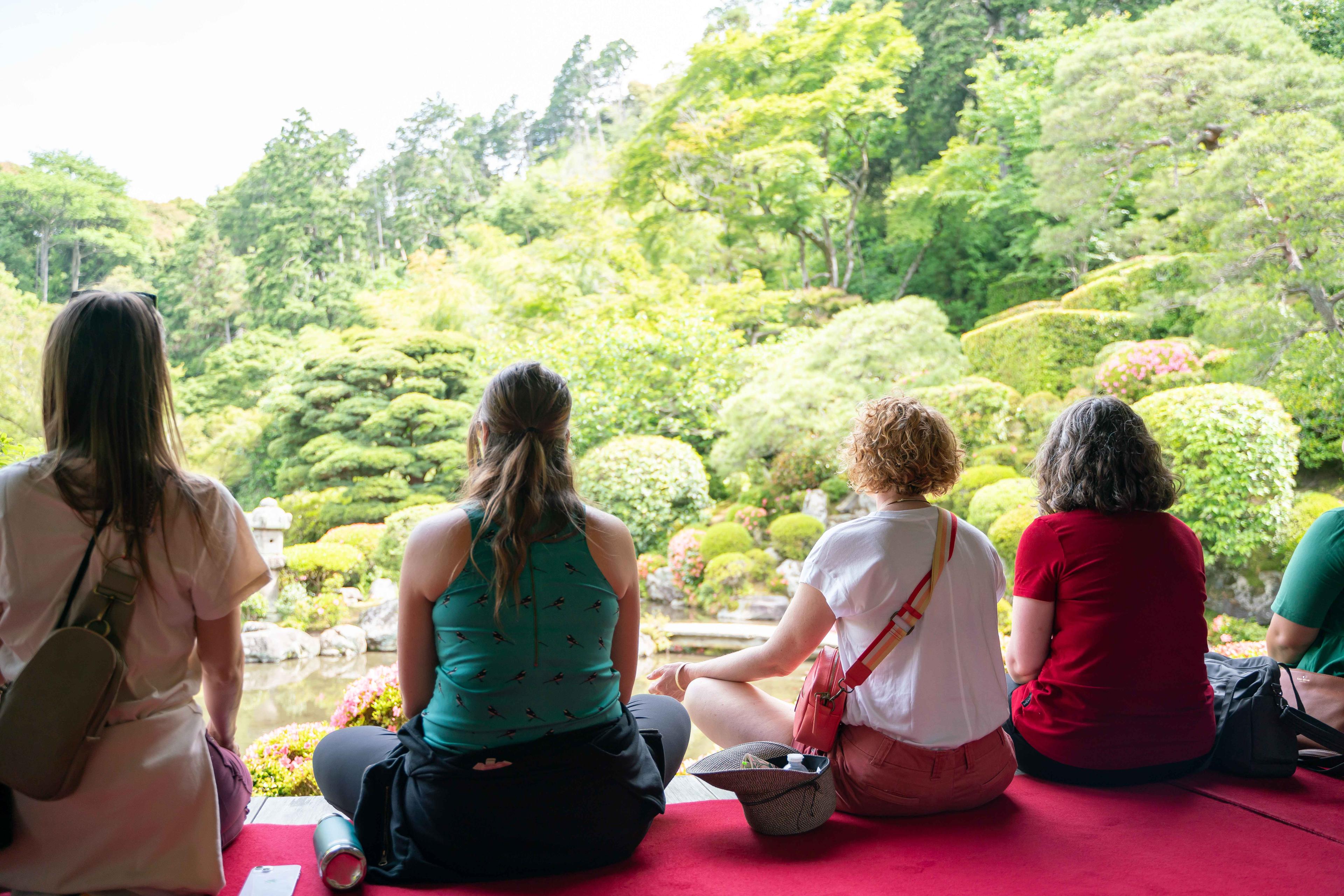 KonMari Consultants take a moment to slow down in front of a Japanese garden to meditate