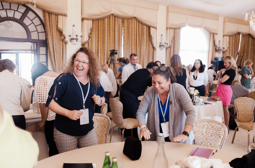women laughing at a round table