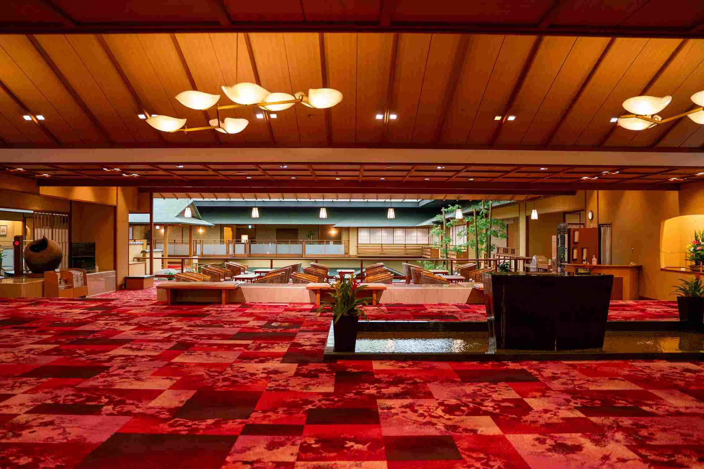 The inside of the ryokan, with red carpet and spacious design