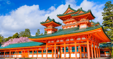A stunning vermillion shrine known as Heian Jingu Shrine, with beautiful dark green roof tiles